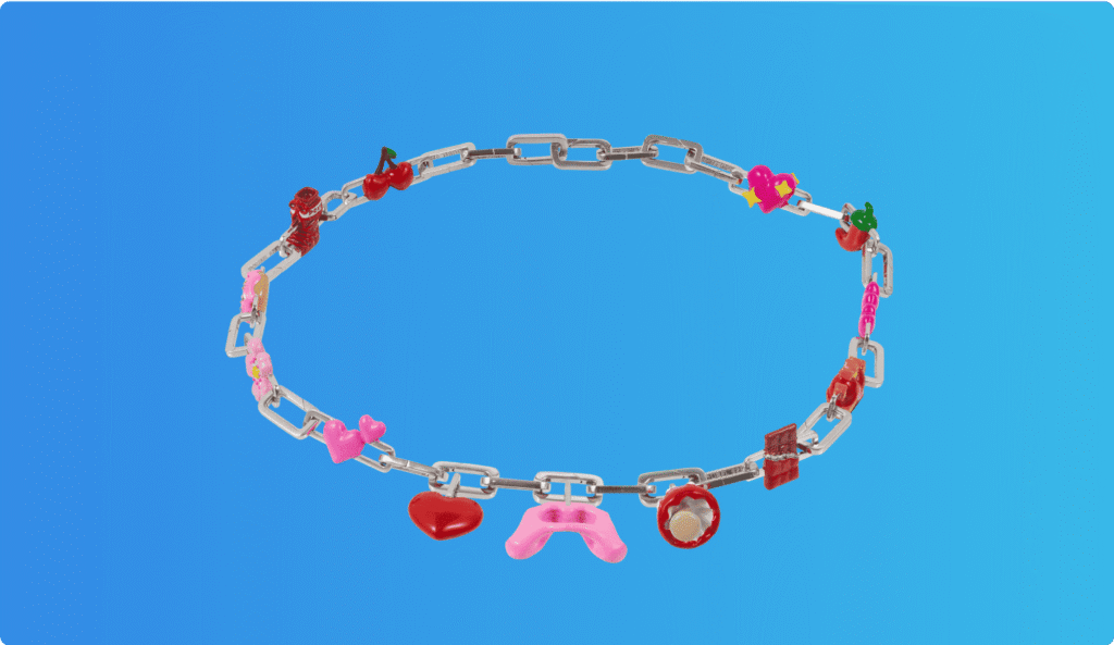 Silver chain necklace with colorful charms including hearts, cherries, flowers, and stars, displayed on a blue background.