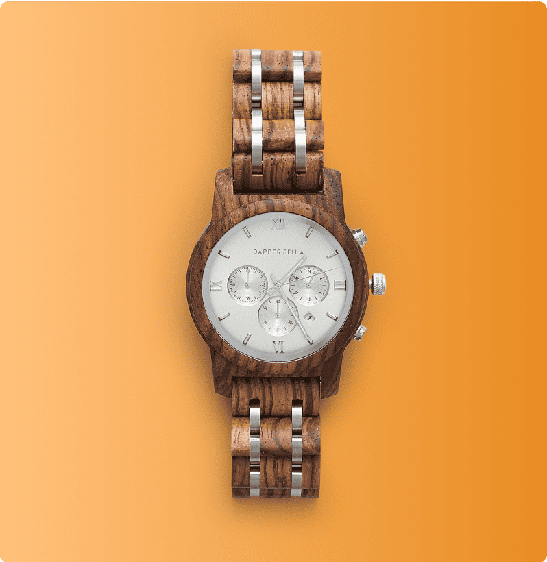 Luxury wooden wristwatch with silver dial and chronograph on orange background.