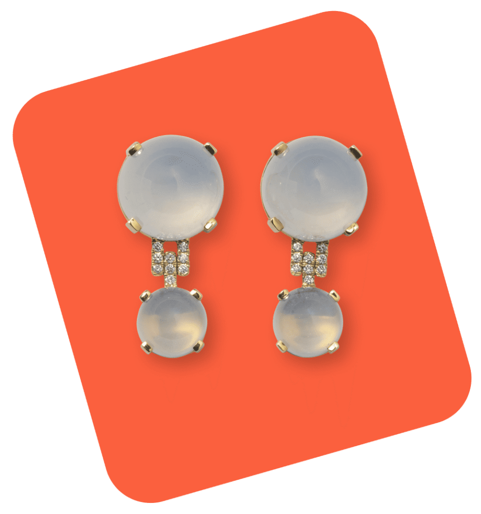 Pair of elegant moonstone drop earrings with gold settings and small diamond accents, displayed on an orange background.