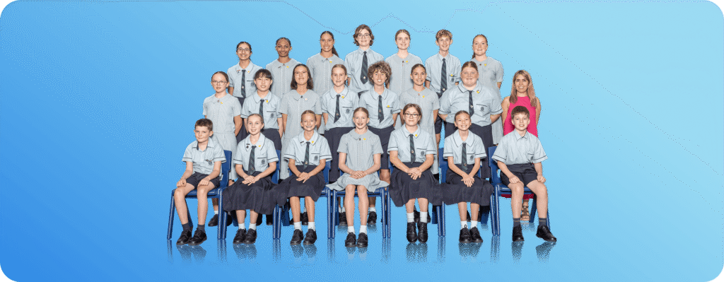 School class group photo of students and teacher in uniform on a blue background.