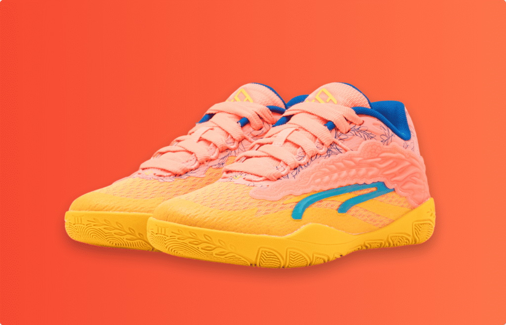 Bright orange and yellow sneakers with pink laces and blue detailing on a solid orange background.