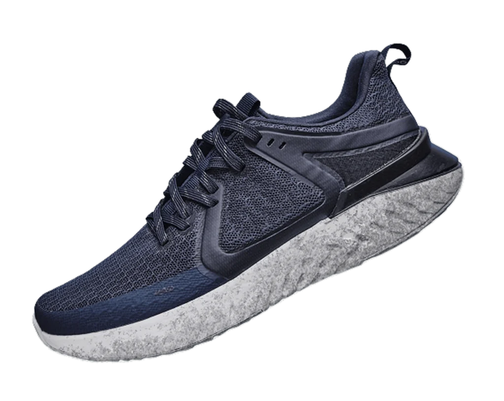 Modern navy blue athletic sneaker with textured mesh upper and white sole on transparent background.