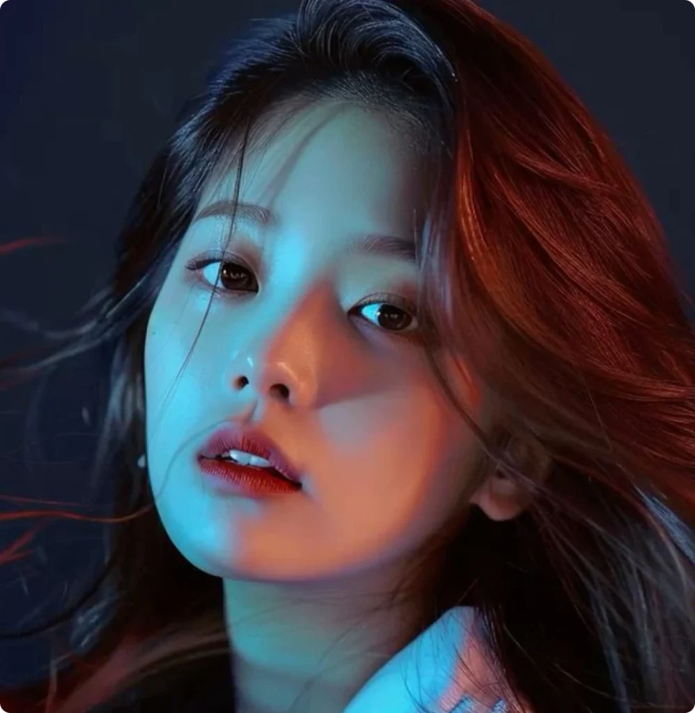 Close-up portrait of a young woman with dramatic blue and red lighting effects