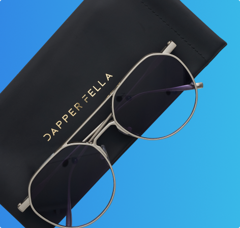 Silver aviator sunglasses with black case displayed on a blue background